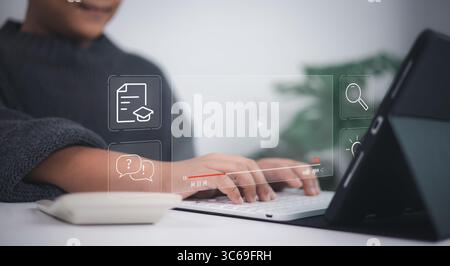 E-learning technology shown as young person types on laptop with virtual icons of education, documents, lightbulb, graduation cap, and question mark, Stock Photo