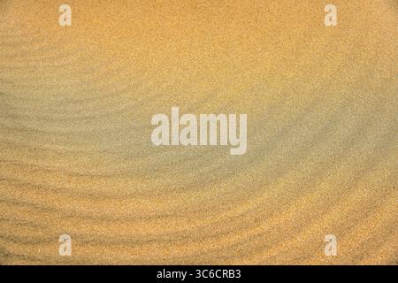 Golden Sand with Gentle Ripple Patterns in Soft Natural Light Stock Photo