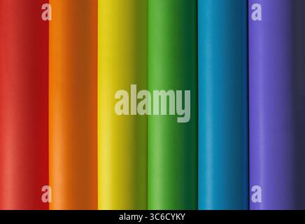 Abstract colorful paper background and backdrop with a vertical row of wave folded paper sheets with rainbow pattern and lgbtq flag colors. Stock Photo