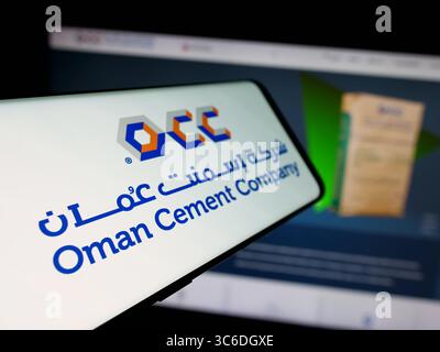 Stuttgart, Germany - 06-20-2025: Smartphone with logo of business Oman Cement Company (OCC) on screen in front of website. Stock Photo