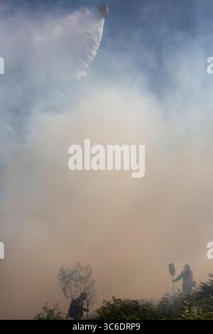 Firefighters try to put out a fire at a shopping center following ...