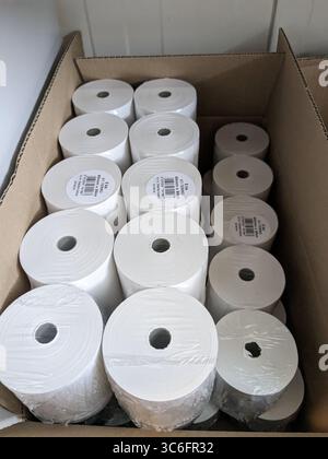 Spare thermal printer rolls for receipt printing stacked in white packaging Stock Photo