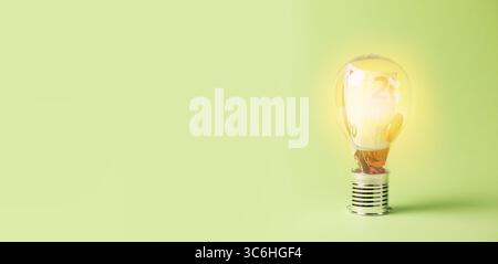 Light Bulb With Money Inside, Increase Of Electricity Price, Eco Friendly Energy Costs, Sustainable Renewable Resources Stock Photo