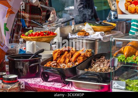 Colorful Asian street food market stall with a selection of fried and boiled meats, street food festival Stock Photo