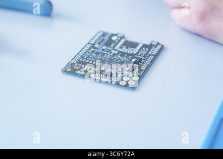 Close-up of a circuit board on a table in focus, blurred background Stock Photo