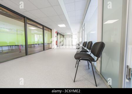 Modern, bright hallway with chairs and glass doors in the waiting area, Care Connect, vaccination kiosk for refugees, Calw, Germany Stock Photo