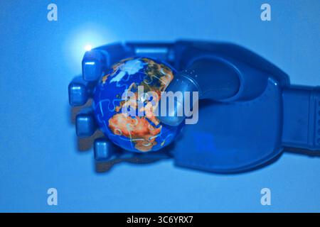 Artificial intelligence and technology shaping global future, robotic hand gently holding planet Earth on light background Stock Photo