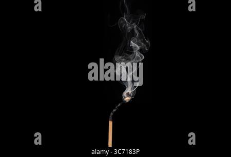 Match with smoke nearly extinguished. Concept of burning out. Stock Photo