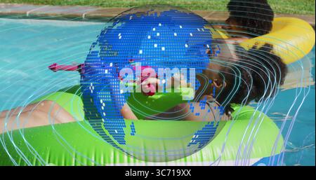 Swimsuit-clad friends floating in backyard pool with green and yellow rings and pink water gun Stock Photo