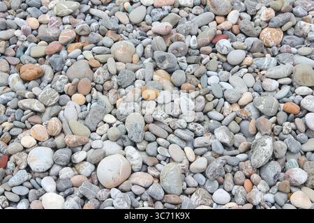 Pebbly beach background from Crete, Greece. Shingle beach. Stock Photo