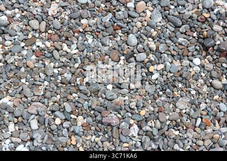 Pebbly beach background from Crete, Greece. Shingle beach. Stock Photo