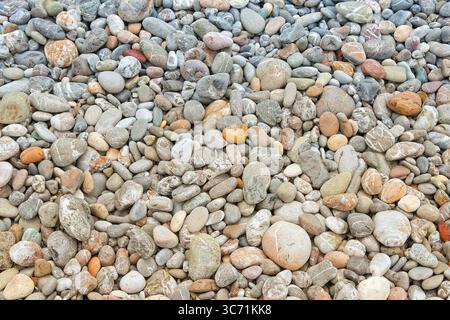 Pebbly beach background from Crete, Greece. Shingle beach. Stock Photo