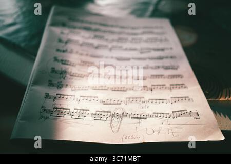 Musical notes with focus on handwritten Forte in foreground. Stock Photo
