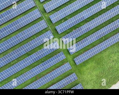 Aerial top view of expansive solar panel farm installation. Renewable energy technology and sustainable electricity production for modern eco friendly Stock Photo