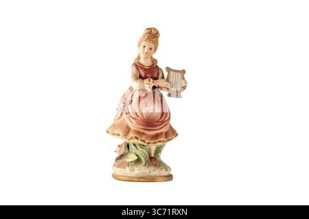 Vintage porcelain period figure of a woman playing a harp isolated on white background Stock Photo