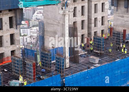 Bangkok, Thailand - 20 December 2024: Construction workers on site at high-rise building Stock Photo