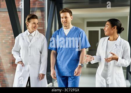 A diverse group of doctors engages in meaningful conversation within a contemporary hospital. Stock Photo