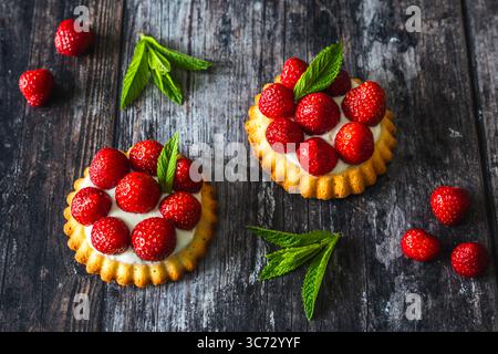 Homemade strawberry tartlets on rustic dark wooden table Stock Photo