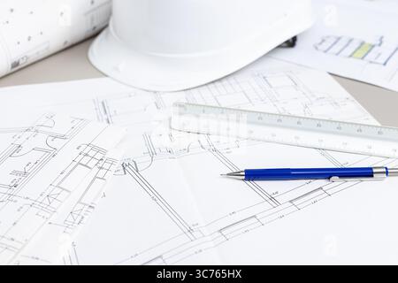 background of a Architectural blueprints and tools on a table, suggesting an architect is working on a project Stock Photo