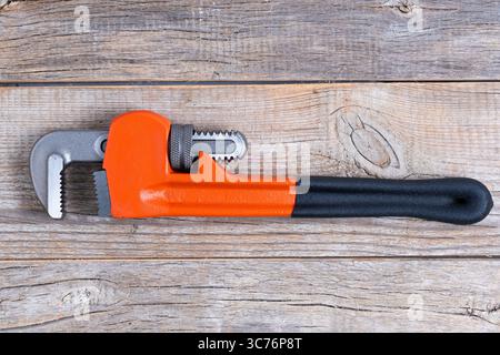 Adjustable pipe wrench on wooden background. Top view with copy space Stock Photo