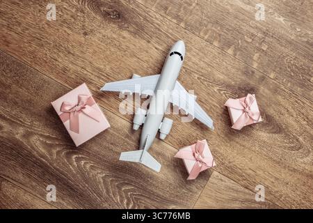 Air delivery. Plane figurine and gift boxes on floor. Flat lay. Top view Stock Photo