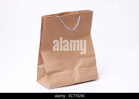 Brown paper bag isolated on white background. Stock Photo