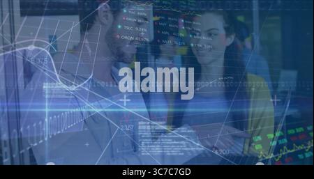Collaborating data professionals examining laptop in modern office, with financial charts overlay Stock Photo