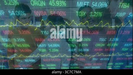Analyzing six professionals examining digital display using tablet in office, with stock graphs Stock Photo