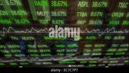 Displaying financial data on computer monitor showing ticker symbols, percentages and line graphs Stock Photo