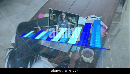 Working designer analyzing holographic bar chart on laptop in home office with color swatch palette Stock Photo