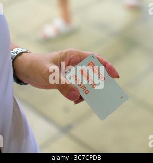 A woman's hand holding a Pasmo card; rechargeable, contactless smart card used for public transportation and shopping in Tokyo, Japan; Tokyo Metro. Stock Photo