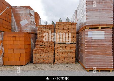 Orange Bricks and Blocks at Stacked Pallets Construction Material Storage Stock Photo