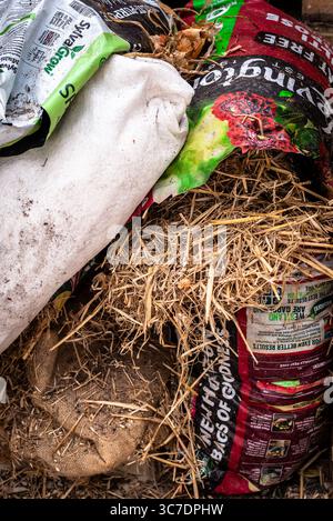 Close up of gardening Materials Including Compost Bags, Straw and Hessian Sacks Stock Photo