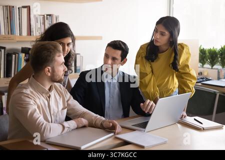 Diverse teammates working on joint online task Stock Photo