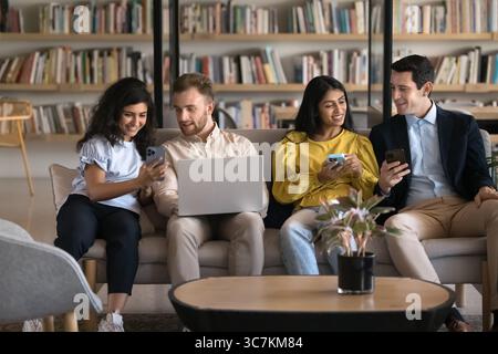 Four people discussing new business application or educations platforms Stock Photo