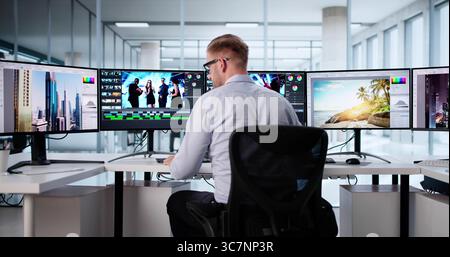 Young Male Graphic Designer Masterfully Edits Photos And Creates Videos. Stock Photo