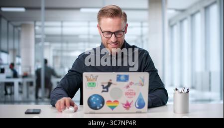 Man Attends Webinar On Laptop To Learn New Graphic Design Skills. Stock Photo