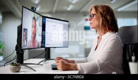 Senior Woman Participates In Virtual Job Interview Using Online Conference Stock Photo