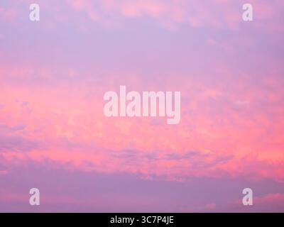 Colorful sky with pink clouds during a beautiful sunset, background Stock Photo