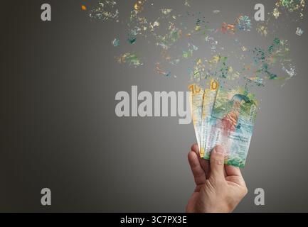 Inflation Money swiss francs vanishing into nothing Stock Photo - Alamy