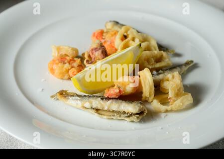Fritto Misto del Golfo Fried Fish with Calamari, Prawns and Sardines Garnished with Lemon Stock Photo
