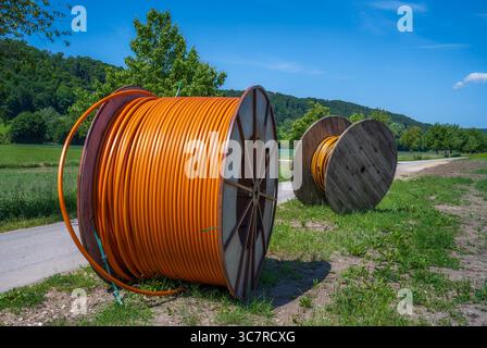 Construction site with a fiber optic cable roll for digital broadband internet communication. Stock Photo