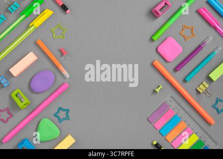 Stationery background of colorful rainbow school and office stationery set on gray background. Flatly, copyspace. Stock Photo