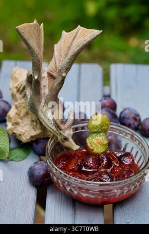 Wild plums on a table and in a glass bowl. Stock Photo