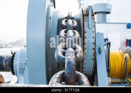 Rusty anchor chain on a winch on a ship. Stock Photo