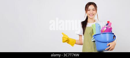 Cleaning supplies woman holds product-filled bucket and gives a bright thumbs up Stock Photo