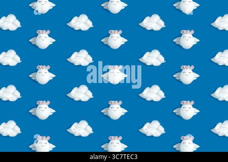 An Easter pattern of angels and clouds on a blue background. Decorated Easter eggs. Stock Photo