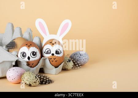 Family of owls. Brown Easter eggs in egg packs. Easter decorations. Stock Photo