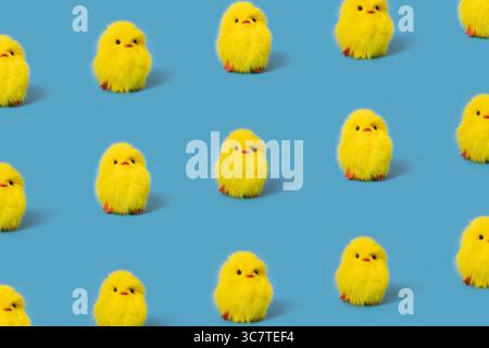 Funny yellow toy chicks on blue background, isometric pattern Stock Photo