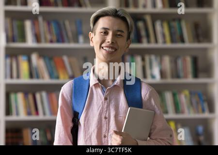Portrait smiling student guy holding digital tablet looking at camera Stock Photo